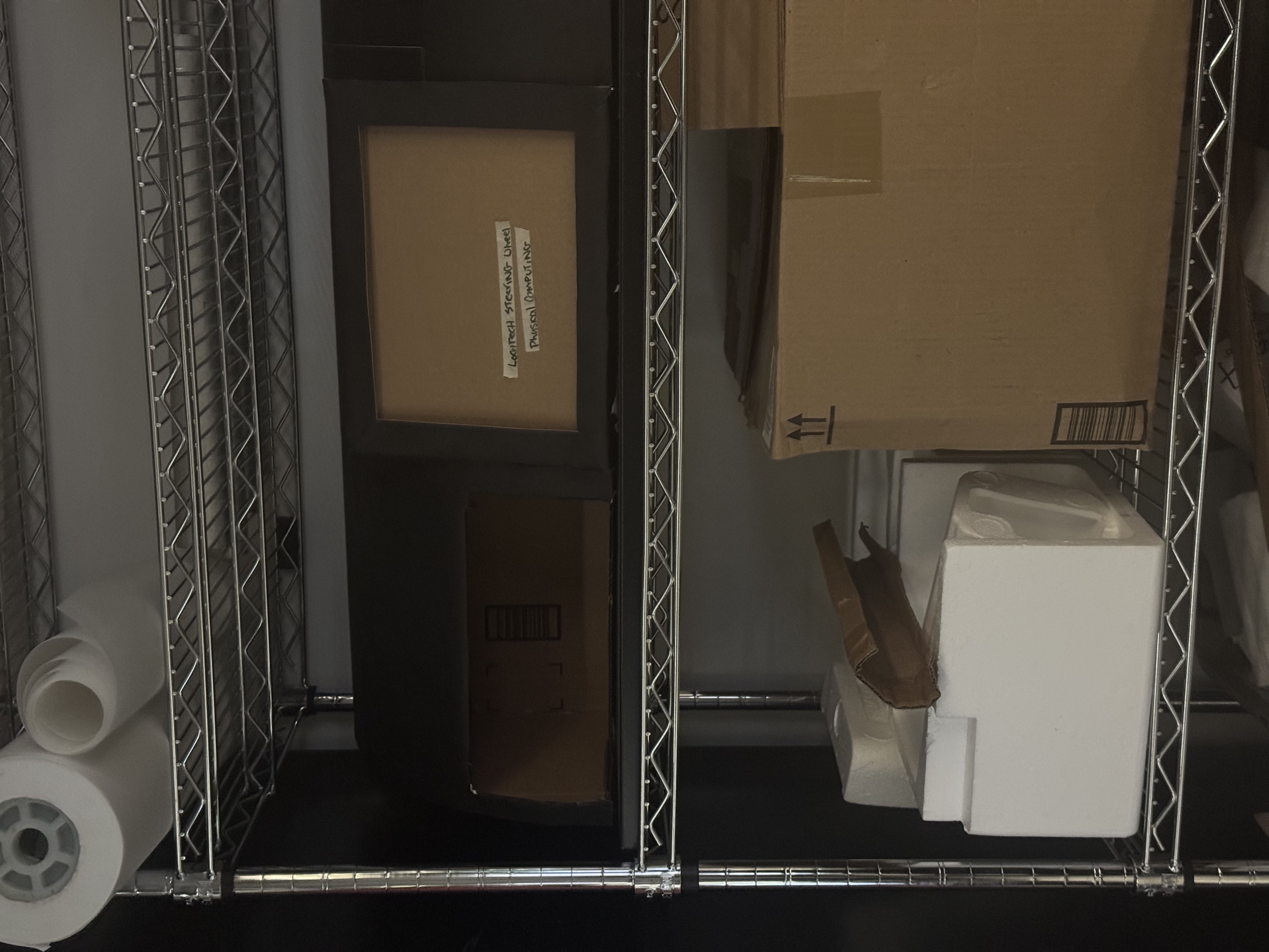 Studio storage shelf with cardboard and foam materials.